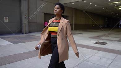 African american black woman tourist with Afro is walking in slow motion.