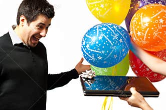 Guy receiving a laptop as a gift