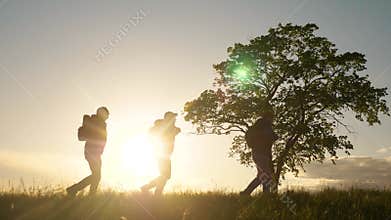 Teamwork. group men silhouette hikers with backpacks walk along trail next go travel to the mountains up top near the