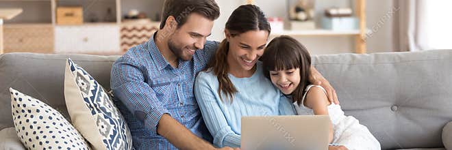 Couple and little daughter using computer watching cartoons on-line