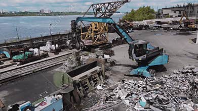 Loader loads metal waste into press recycling machine
