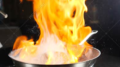 Chef making steak fillet mignon in flambe style on a grill pan. Cooking in restaurant in slow motion. Cooking Beef meat