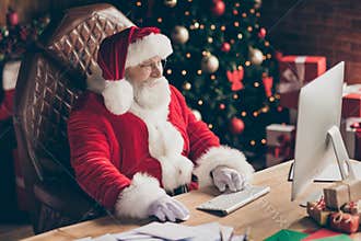 Profile side photo of santa claus sit table desk work computer before x-mas christmas night midnight check email read