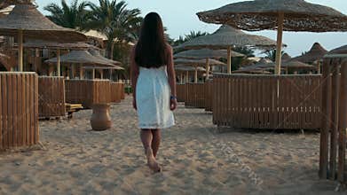 Barefoot woman spending summer holiday at sand seaside in egyptian resort.