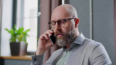 Businessman Focused On Conversation By Phone With Employee .