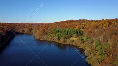 Aerial, beautiful changing colors along Lake Mohegan, New England