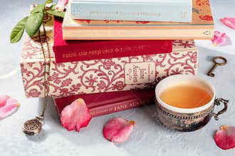 Madrid, Spain - September 2, 2020: Books by Jane Austen and about her in a stack, with a tea cup and some vintage objects