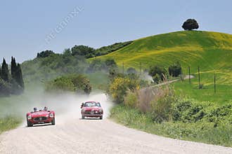 A 1954 red Maserati and a 1955 Alfa Romeo