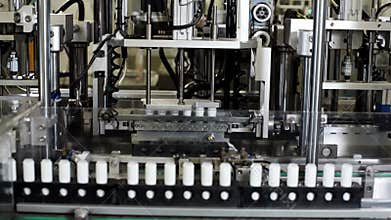 Lipstick on automated conveyor cosmetic factory. Manufacture lipstick in factory