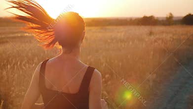 Young fitness sport woman running on road at sunset. Athlete runner feet running on road, slow motion.