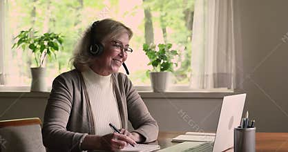 Granny wear headset use laptop get virtual consultation by videocall