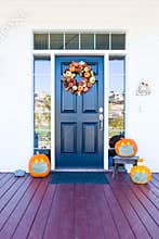 Beautiful House Porch Decorated For Halloween with Pumpkins Wearing Medical Face Masks