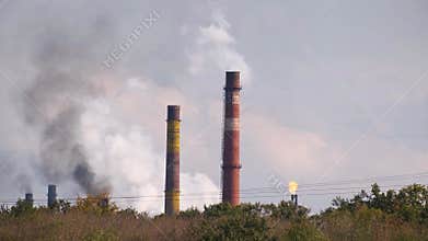 Smoke of factory pipes .Global environmental problem of air and nature pollution by industries plants.