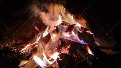 campfire of books at night
