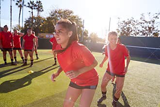 Womens Football Team Training For Soccer Match On Outdoor Astro Turf Pitch