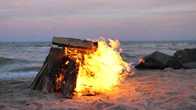 A bonfire is burning on the beach