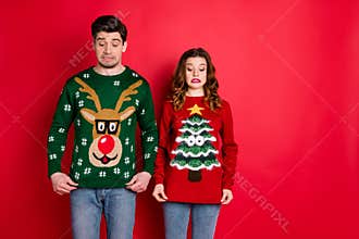 What disgust. Portrait of frustrated two brunette haired students stare at deer christmas tree design jumper displeased