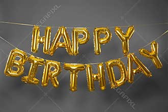 Phrase HAPPY BIRTHDAY made of golden  letters on grey background