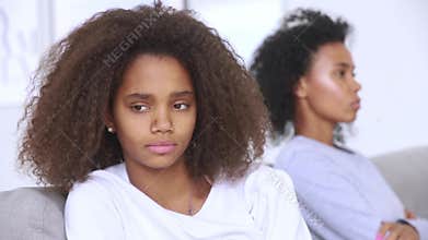 Focus on african daughter sitting separately of mother after conflict