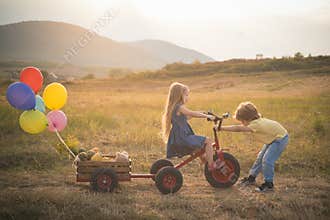 Bike riding - children on bike. Farming and agriculture cultivation. Active family leisure with kids. sweet childhood