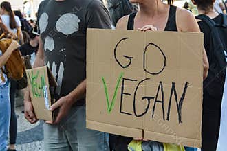 Activists with `Go Vegan` placards