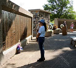 Woman Standing by the EAA Memorial Wall in Oshkosh WI remembering a loved one