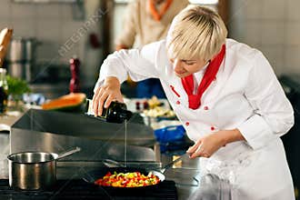 Chefs in a restaurant or hotel kitchen cooking