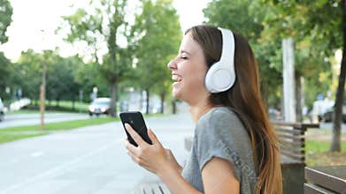 Girl listening to music and dancing in the street