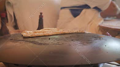 Woman making tortillas in traditional way. Authentic handmade tortillas.