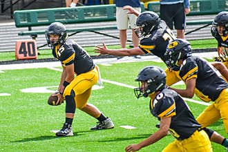 Football Players Running On Field