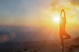 Young women meditate while doing yoga meditation, spiritual mental health practice with silhouette of lotus pose having peaceful