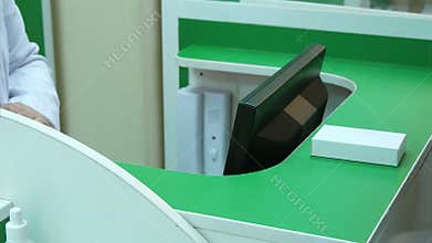 Pharmacist holding tablets in hands and gave them to customer, who pay with dollars cash