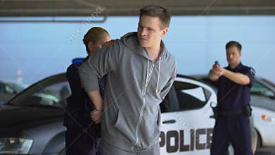 Cops arresting criminal, male officer aiming gun, police woman wearing handcuffs