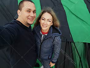 Adventure love couple on hot air balloon watermelon. Man and woman kiss hug love each other. Burner directing flame into