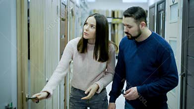 Married couple chooses interior doors in a construction supermarket.