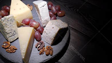 An assortment of wine appetizers, appetizers or gourmet dinners. Top view, close distance, a wedge of cheese, on a rare