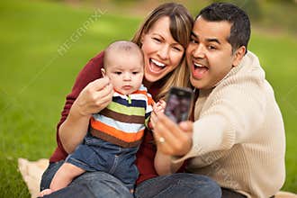 Happy Mixed Race Parents and Baby Boy with Camera