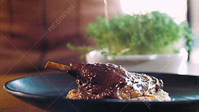 Chef adding a microgreens on roasted duck at restaurant