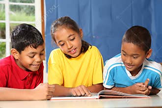 Primary school kids learning together in classroom