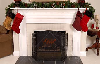 White fireplace decorated for Christmas