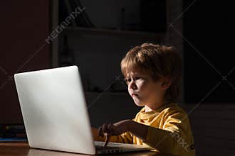Cybercrime concept. Male hacker working on a computer in Data center filled with monitor screens. Kids using laptop in