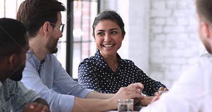 Smiling indian hr member talking to job applicant during interview