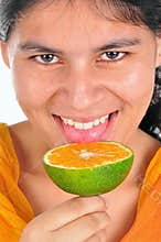 Girl licking orange