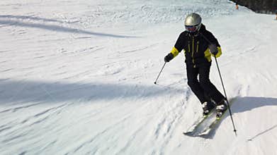 Professional skier skiing on sunny winter day