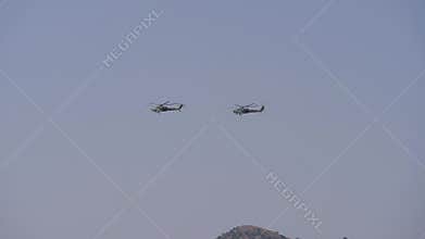 Flying a couple of helicopters over the mountains. Aerobatics.