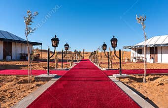 Red Carpet Main path between the tents of luxury Golden Camp site in Sahara Desert Merzouga, Morocco on a sunny day
