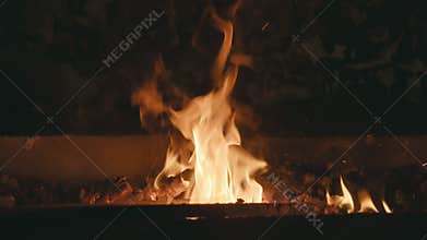 Forge fire in furnace. Blacksmith tempers a steel product in a stove. Smithy forging for hardening and heating iron