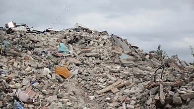 Earthquake ruins and damaged buildings. Destroyed and collapsed houses in town. Wreckage and debris. Piles of bricks, dust, concre