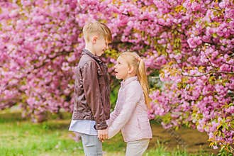 Love is in the air. Tender love feelings. Little girl and boy. Romantic date in park. Spring time to fall in love. Kids