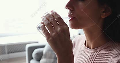 Young dehydrated woman drinking fresh pure mineral pure water, closeup